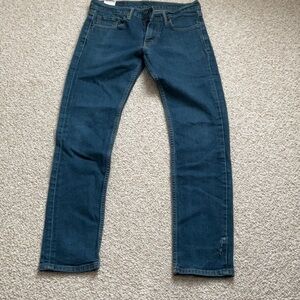 LEVI’S 511 blue jeans. Small tear for that distressed look.